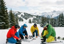 Ski : quelles sont les blessures les plus fréquentes et comment les prévenir ? Groupe de skieurs ajustant leur équipement en montagne